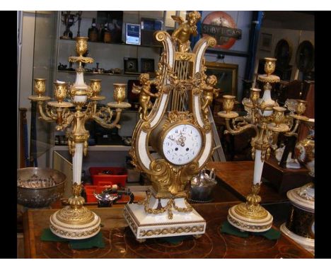 An impressive 19th century French Garniture de Chimene Lyre clock with cherub and garland ormolu mounts, striking movement by