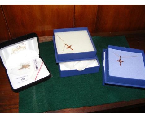 Two 9ct gold ruby and diamond cross pendants together with a gold cross on chain