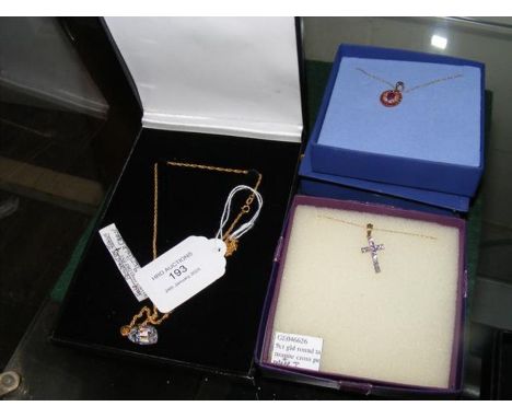 A 9ct gold ruby pendant on chain together with two others