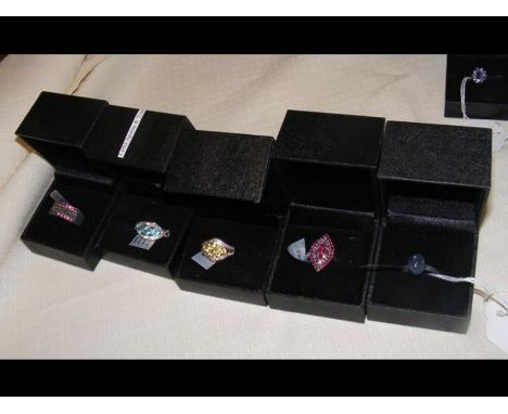 A white topaz dress ring in silver setting and four others