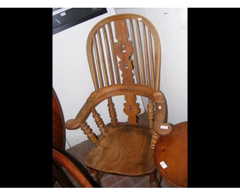 An antique country stick back armchair