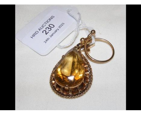 A pear shaped pendant in gilt surround together with a ring