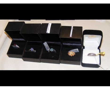 A ruby dress ring in silver setting together with four others
