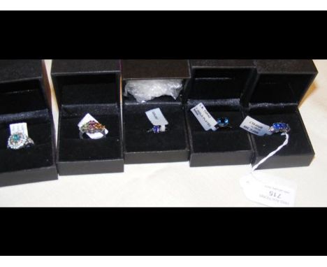 A kyanite and white topaz ring in silver setting together with four others