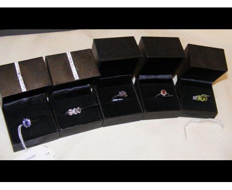 A peridot and topaz sterling silver dress ring and four others