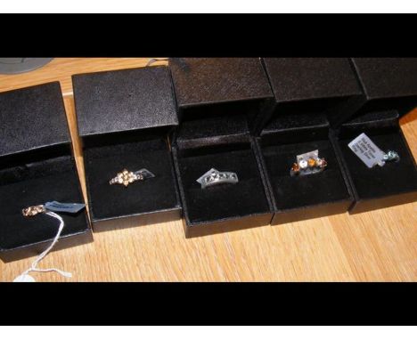 A blue apatite and white topaz dress ring in silver setting together with four others