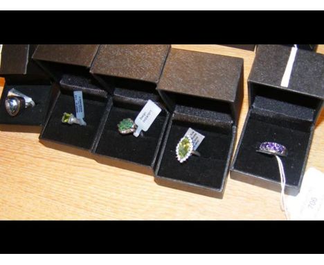 A green quartz dress ring in silver setting together with four others