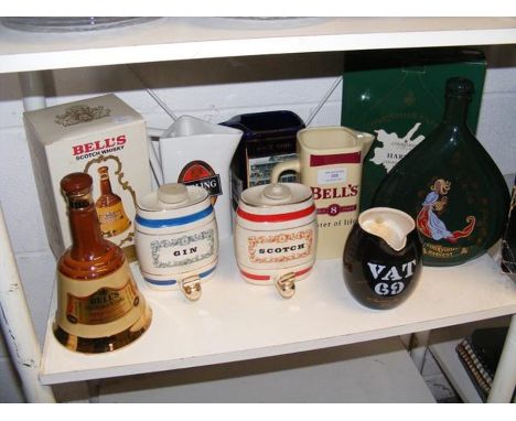 An unopened bottle of Bells Old Scotch Whisky in ceramic Wade bell, together with assorted spirit jugs and decanters 