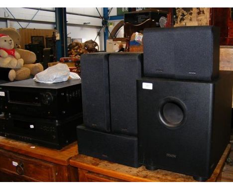 A speaker system and a Denon speaker system and Harman/Kardon disc player 