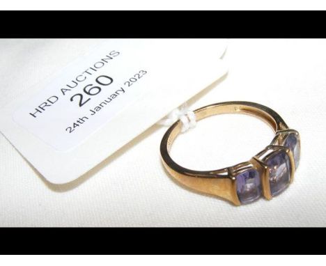 A three stone dress ring in 9ct setting