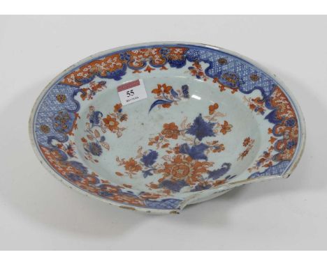 An 18th century Chinese export porcelain barber's bowl, underglaze blue and red enamel decorated with flowers, dia.27cmGlaze 