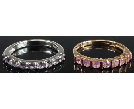 A contemporary 9ct white gold and tanzanite set half-hoop ring, size L; together with a rose gold and pink stone half-hoop ri