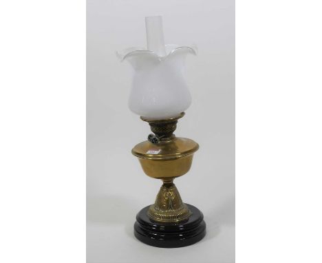 A 19th century brass oil lamp, having a milk glass shade, h.55cm 