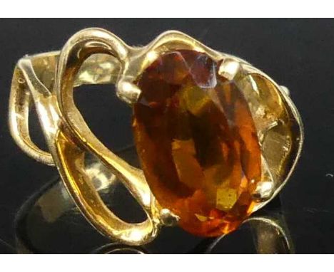 A contemporary yellow metal and orange citrine set dress ring, the four-claw set oval cut citrine measuring approx 12.9 x 7.8