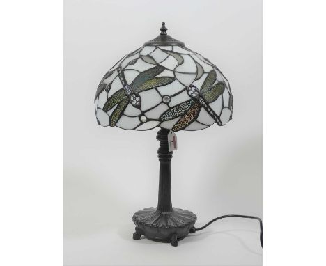 A Tiffany style table lamp, having a stained glass shade, decorated with dragonflies, h.49cm 