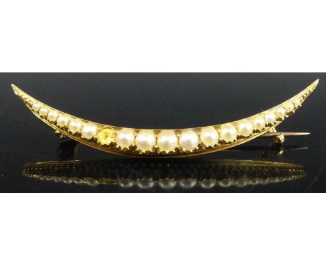 A yellow metal and cultured graduated seed pearl set crescent brooch, unmarked but tests as approx 15ct gold, pin tests as 9c