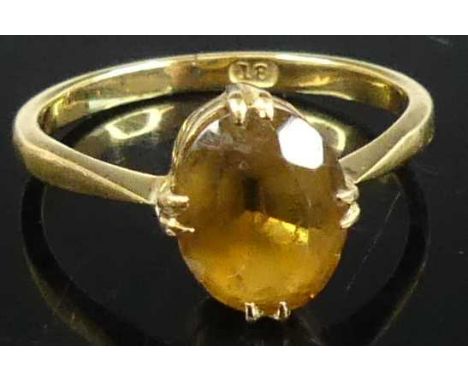 An 18ct gold and oval cut citrine dress ring, the citrine measuring approx 9.5 x 7.4 x 4.6mm, 3g, size N