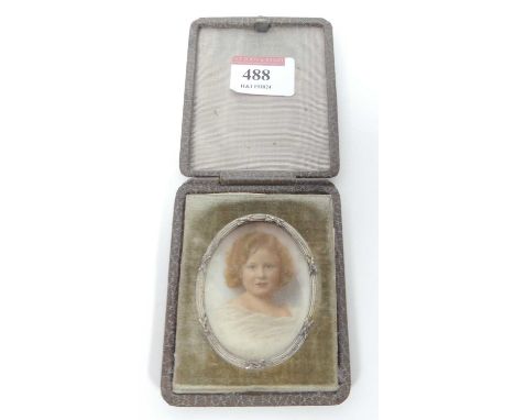 Early C20th English school, portrait miniature of a child, watercolour on ivory, all housed in a leather clad travelling case