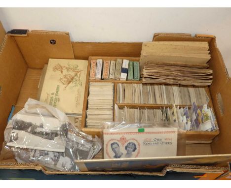 A collection of vintage cigarette cards and postcards