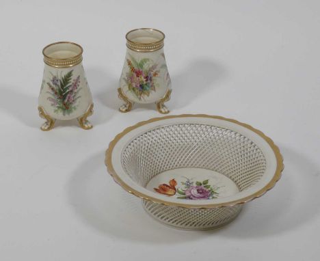 A pair of Worcester vases, each enamel decorated with flowers and standing upon three paw feet, h.12.5cm; together with a con