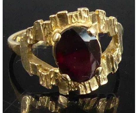 A modern 9ct gold garnet set dress ring, the four-claw set oval cut garnet in a stylised setting, 3.4g, sponsor FM, size O 