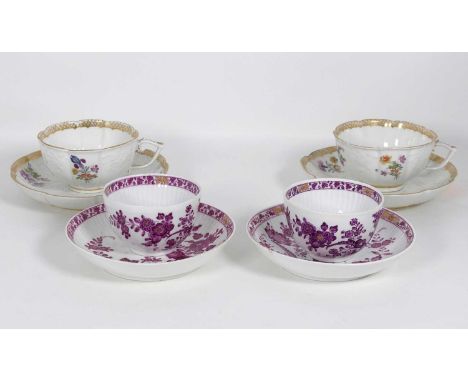 A pair of Meissen porcelain tea cups and saucers, each decorated with flowers within a gilt border, saucer dia.14cm; together