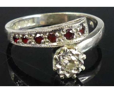 A contemporary 9ct white gold illusion diamond and garnet crossover ring, size M, 3.4g