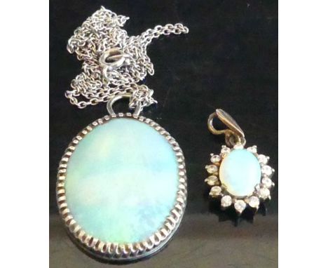 An opal pendant in white metal mount, measuring approx 26 x 20mm, on finelink neck chain; together with another smaller examp