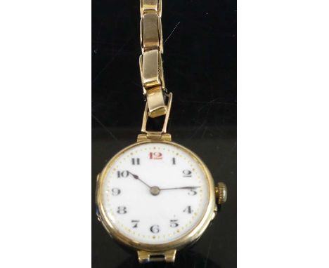 A vintage lady's 15ct gold cased manual wind wristwatch, with white enamel Arabic dial, approx 16g, on gilt metal expanding l