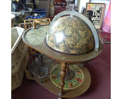 A vintage globe drinks trolley, with under tier shelf raised on casters 