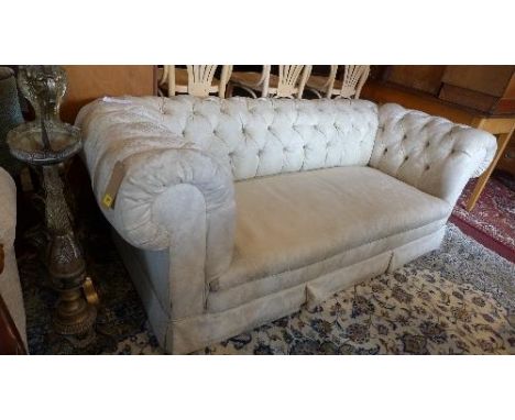 A Victorian drop end Chesterfield sofa, with button back upholstery, raised on bun feet 