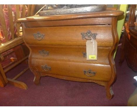 A 20th Century Dutch design oak commode of small proportions, with three drawers raised on shaped supports, H.62cm W.66cm D.3