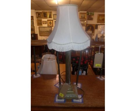 An Edwardian brass Corinthian column form table lamp with tasseled shade 