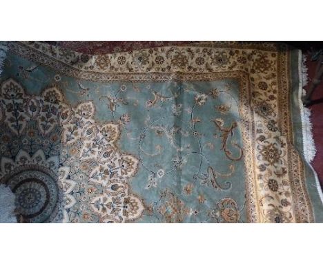 A Kashan style carpet, with central floral medallion on a green ground, contained by floral borders, 280 x 200cm 