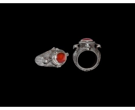 19th-20th century AD. A silver finger ring comprising a D-section hoop with two inset red glass(?) panels to the underside, t
