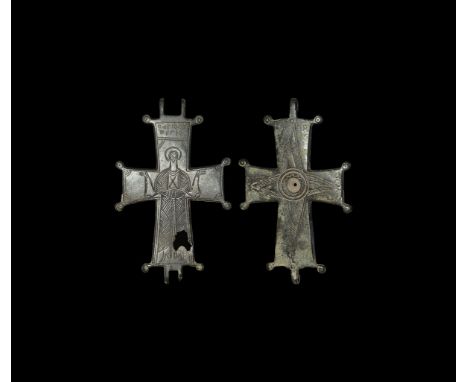 10th-12th century AD. A high-tin bronze reliquary cross pendant with hinge, to one face a full-length standing robed nimbate 