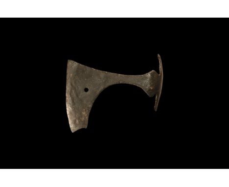 9th-11th century AD. A hand forged iron axehead with triangular-section blade, narrow neck widening to a broad bevelled edge 
