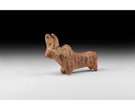 3rd millennium BC. A ceramic figure of a bull with curving horns and hump to the back; long body with short legs; pigment dec