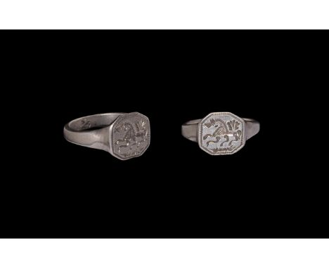 14th-15th century AD. A silver finger ring comprising a square-section shank, flared shoulders, octagonal plaque with beaded 