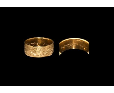 19th century AD. A barrel-shaped gold finger ring with leaf and tendril detailing to the outer face, inscribed to the inner f