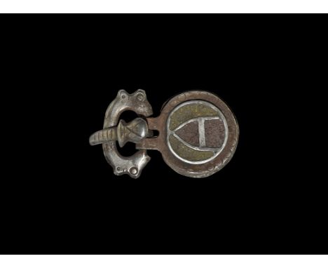7th-8th century AD. A silver buckle comprising: a flat-section loop with animal-head terminals; a curved tongue with violin-s