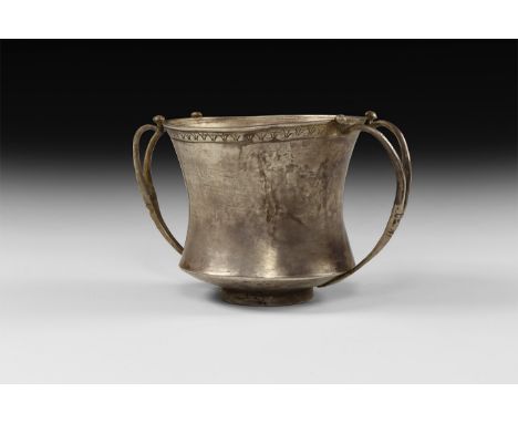 4th-1st century BC. A silver kantharos or wine cup with a deep waisted body, applied basal ring, delicate applied twin handle