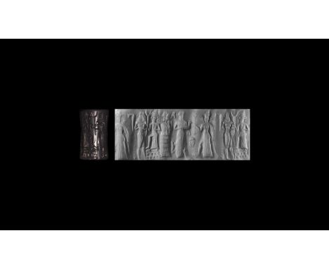 20th-17th century BC. A carved haematite cylinder seal depicting two god scenes, accompanied by a museum quality impression a