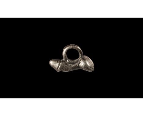 1st-2nd century AD. A silver pendant of an erect phallus; suspension ring to the top.   11 grams, 26mm (1"). From a private c