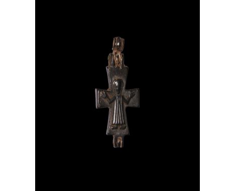 10th-12th century AD. A bronze reliquary cross pendant with high-relief figure to each face, one Corpus Christi with arms spr