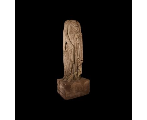 13th-15th century AD. A carved limestone statue depicting a standing torso in full-length robe partly covered by a cloak pinn