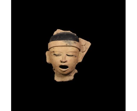 Late Post Classic Period, 14th-16th century AD. A ceramic head of the god Xipe Totec, 'Our Flayed Lord', representing the fla