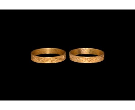 13th-14th century AD. A gold finger ring comprising a flat-section hoop with high-relief running vinescroll to the outer face