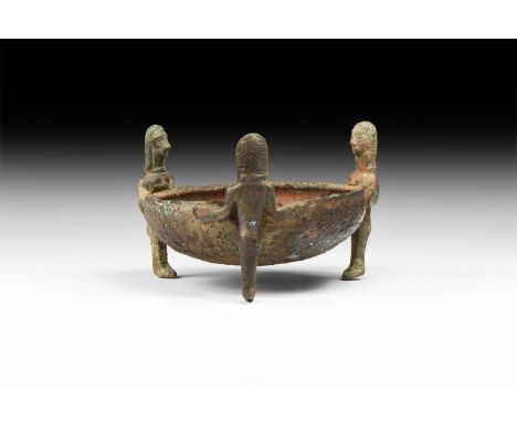 6th-4th century BC. A hemispherical bowl with chamfered lip, three legs formed as standing nude female figures facing the cen