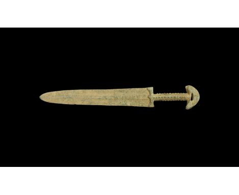 13th century BC. A bronze dagger with broad lentoid-section blade, hilt with guard and columnar grip with ribbing, openwork D